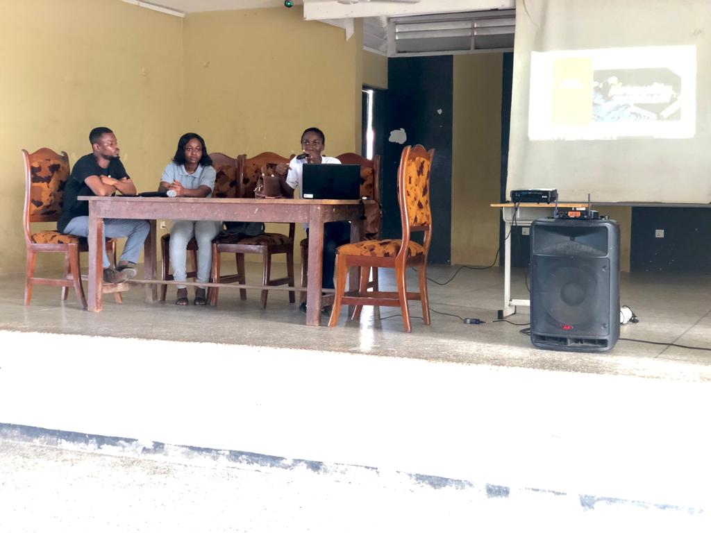 A group of young people presenting at a table