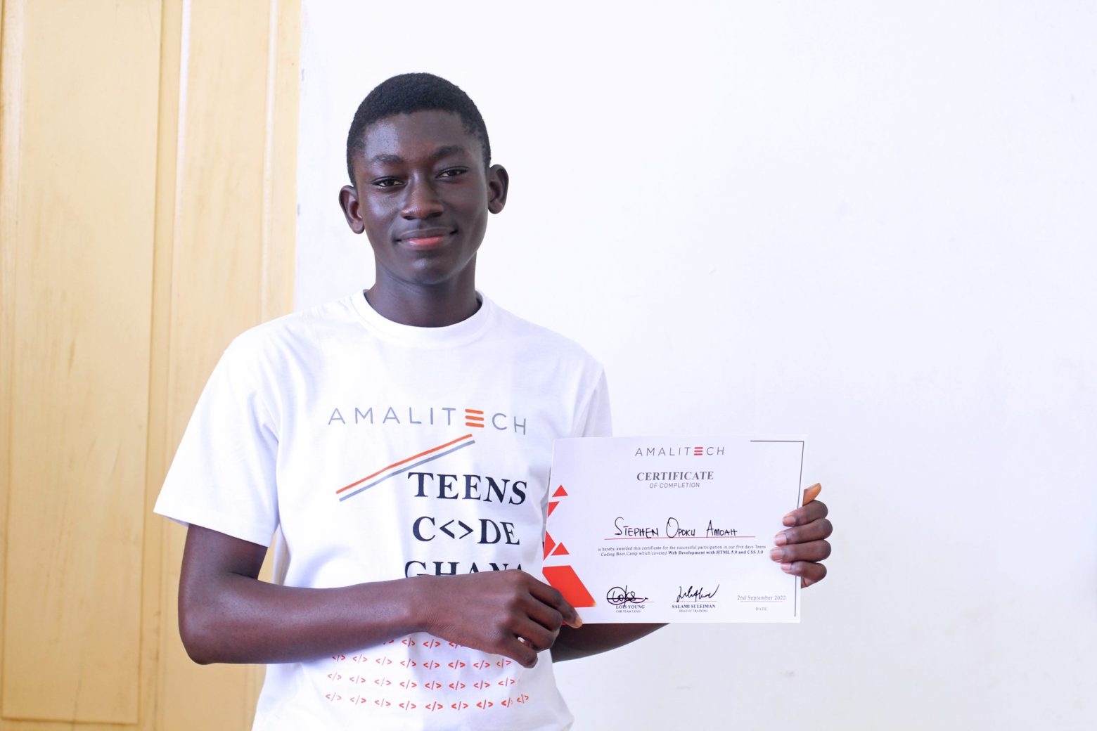 a teen holding his issued certificate