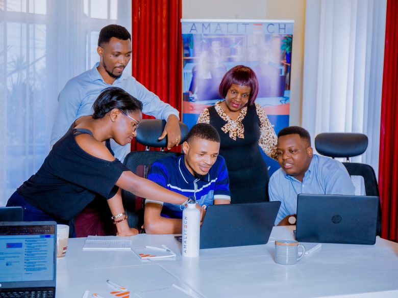 A group of employees collaborating behind a computer